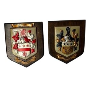 wooden plaques featuring family crests or coats of arms. McBrayer and Fllington.